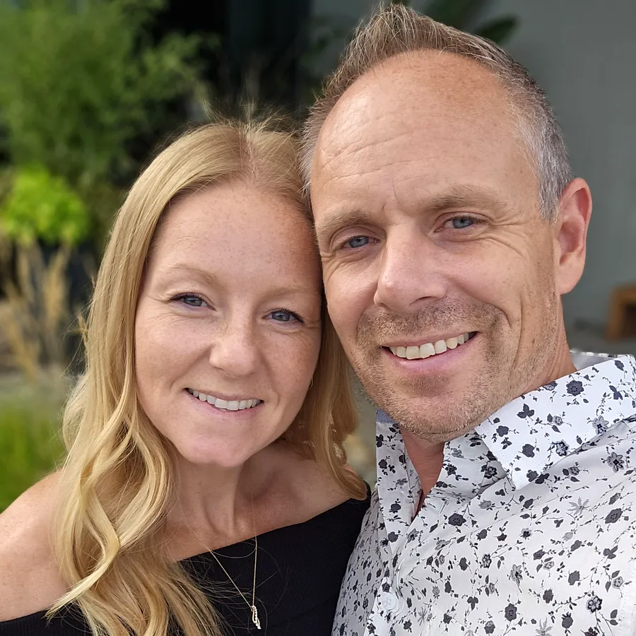 Chad Giesbrecht of Pixel Pro Productions and his wife Heather, wedding photographer at Heatherly Photography, smiling together