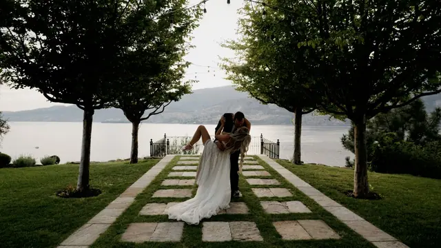 Kissing dip by the lake: Kiana & Nick's wedding at Chateau Okanagan, Kelowna. Still from the Pixel Pro wedding film.