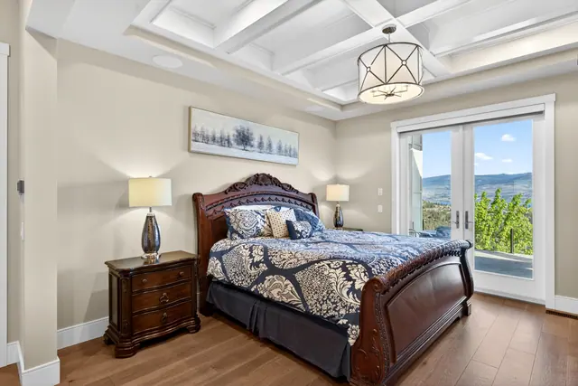 Primary bedroom, lake-view family home in West Kelowna, BC. Real estate photography by Pixel Pro Productions.