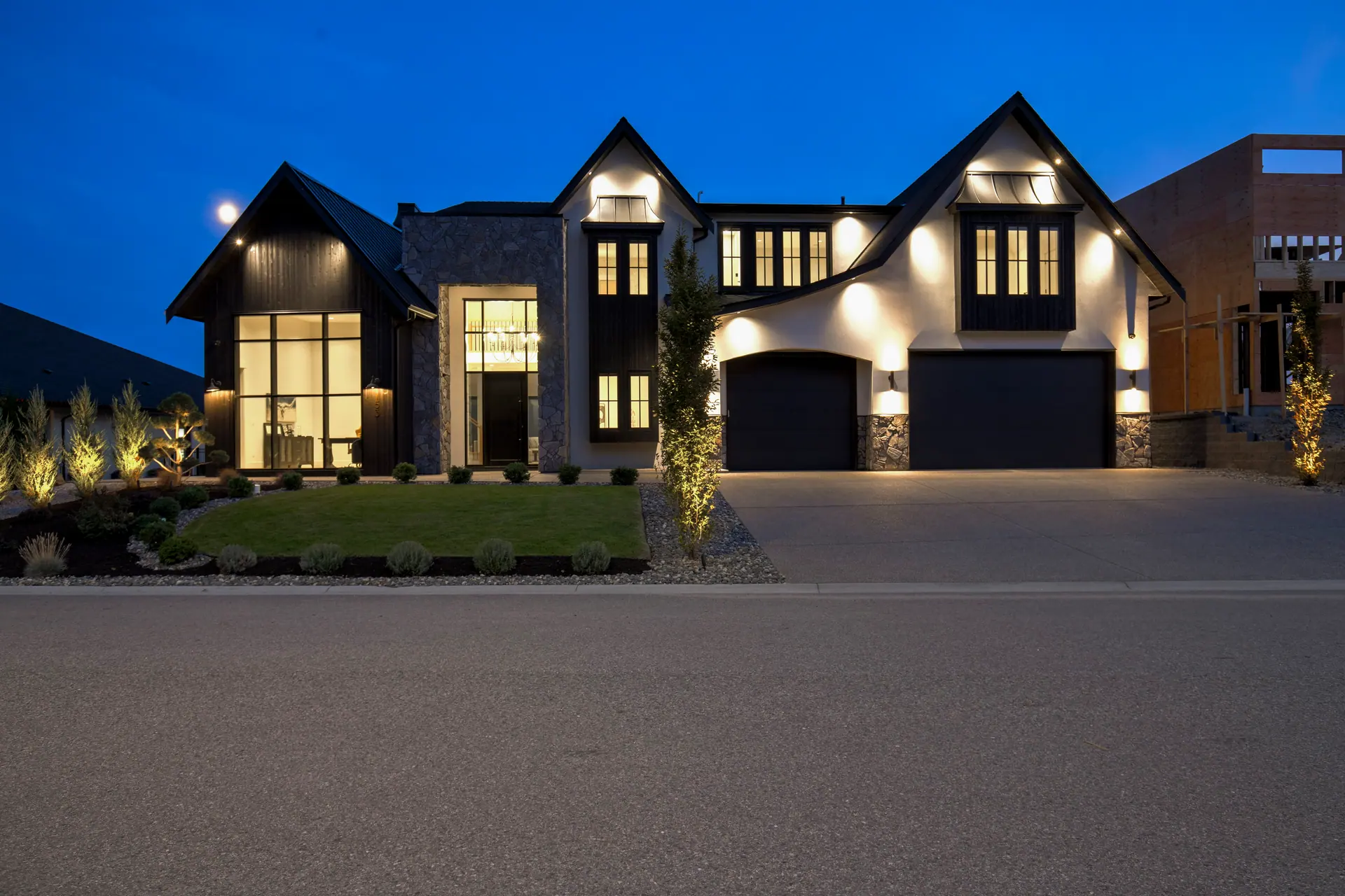 Twilight exterior, modern farmhouse new build in West Kelowna, BC. Real estate photography by Pixel Pro Productions.